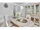 Formal dining room boasting a mirrored dining table, seating for six, and a designer cabinet at 2026 Rosewater Ln, Indian Trail, NC 28079