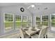 Bright dining room with natural light, white marble table and seating for six at 2026 Rosewater Ln, Indian Trail, NC 28079