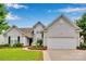Charming two-story home with manicured lawn and flower beds, showcasing curb appeal and a welcoming entrance at 2026 Rosewater Ln, Indian Trail, NC 28079