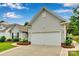 Spacious two-car garage with well-kept landscaping and symmetrical architectural details at 2026 Rosewater Ln, Indian Trail, NC 28079