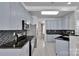Modern kitchen with black countertops, stainless steel appliances, and blue cabinetry at 2026 Rosewater Ln, Indian Trail, NC 28079
