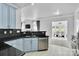 Open-concept kitchen featuring stainless steel appliances, black granite countertops, and modern backsplash at 2026 Rosewater Ln, Indian Trail, NC 28079