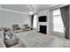 Living room features a fireplace, large windows, stylish sofas, and a crystal chandelier at 2026 Rosewater Ln, Indian Trail, NC 28079