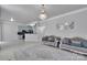 Open living room with sofas, chandelier, and eat-in kitchen with blue cabinetry and black countertops at 2026 Rosewater Ln, Indian Trail, NC 28079