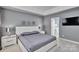 This primary bedroom suite features tray ceiling, nightstands with lamps, and an ensuite bathroom at 2026 Rosewater Ln, Indian Trail, NC 28079
