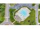 Aerial view of a community pool featuring unique shape, lounge chairs, umbrellas, and ample parking at 2026 Rosewater Ln, Indian Trail, NC 28079