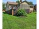 The home features an elevated screened-in porch with stairs to a lush lawn at 217 Rock Creek Dr, Lincolnton, NC 28092
