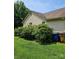 Side view of home exterior with mature landscaping and a well-maintained lawn at 217 Rock Creek Dr, Lincolnton, NC 28092