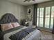 Bedroom with a tufted headboard and a vanity, illuminated by natural light at 217 Rock Creek Dr, Lincolnton, NC 28092