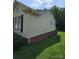 Exterior side view of home with vinyl siding and brick foundation at 217 Rock Creek Dr, Lincolnton, NC 28092