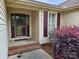 Inviting front porch with decorative door, shutters, and landscaped with attractive plantings at 217 Rock Creek Dr, Lincolnton, NC 28092