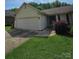 Charming single-story home with a well-manicured front yard and two car garage at 217 Rock Creek Dr, Lincolnton, NC 28092