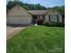 Charming single-story home with a well-manicured front yard and two car garage at 217 Rock Creek Dr, Lincolnton, NC 28092