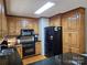 Functional kitchen with black appliances, wooden cabinets, and granite countertops at 217 Rock Creek Dr, Lincolnton, NC 28092