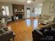 Spacious living room featuring hardwood floors, a brick fireplace, and ample natural light at 217 Rock Creek Dr, Lincolnton, NC 28092