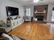 Comfortable living room with brick fireplace, hardwood floors, and neutral tones at 217 Rock Creek Dr, Lincolnton, NC 28092