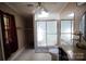 Bathroom featuring a tiled floor, a glass door shower, and a large mirror above the toilet at 220 Singing Pine Dr, Clover, SC 29710