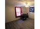 Well-lit bedroom with gray floors and a window adorned with red curtains at 220 Singing Pine Dr, Clover, SC 29710