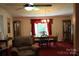 Traditional dining room featuring a ceiling fan and chandelier above wood dining table at 220 Singing Pine Dr, Clover, SC 29710