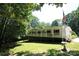 Inviting exterior of a white raised home with a wrap-around porch and a lush green lawn at 220 Singing Pine Dr, Clover, SC 29710