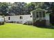 Exterior view of a white home with a screened porch at 220 Singing Pine Dr, Clover, SC 29710