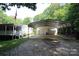 Spacious two-car garage and carport with a gravel driveway at 220 Singing Pine Dr, Clover, SC 29710