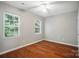 Bedroom with two windows, ceiling fan, and wood flooring at 2239 Blue Hampton Ln, Charlotte, NC 28213