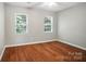 Bedroom with two windows, ceiling fan, and wood flooring at 2239 Blue Hampton Ln, Charlotte, NC 28213