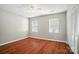 Bedroom featuring two windows, ceiling fan, and laminate flooring at 2239 Blue Hampton Ln, Charlotte, NC 28213