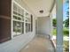 Inviting covered front porch with classic support columns, neutral siding, and a secure screen door at 2239 Blue Hampton Ln, Charlotte, NC 28213
