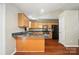 Kitchen with stone countertops, stainless steel appliances, and wood floors at 2239 Blue Hampton Ln, Charlotte, NC 28213