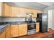 Kitchen with stainless steel appliances, wood cabinets, and stone countertops at 2239 Blue Hampton Ln, Charlotte, NC 28213