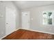 Bright living room featuring light walls, new hardwood floors, and great natural light at 2239 Blue Hampton Ln, Charlotte, NC 28213