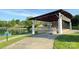 Outdoor amphitheater with covered stage area overlooking a grassy lawn near the lake at 240 Orson Oaks Ln, Pineville, NC 28134