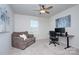 Cozy bedroom featuring carpet flooring, ceiling fan, and a comfortable sitting area at 240 Orson Oaks Ln, Pineville, NC 28134