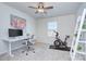 Well-lit bedroom featuring carpet flooring, a ceiling fan, and a dedicated workspace at 240 Orson Oaks Ln, Pineville, NC 28134