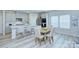 Open-concept dining area with modern chairs and kitchen with stainless steel appliances at 240 Orson Oaks Ln, Pineville, NC 28134