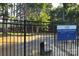 Fenced dog park with trees and gravel at 240 Orson Oaks Ln, Pineville, NC 28134