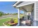 Inviting front porch with stone accents and seating, offering a relaxing outdoor space at 240 Orson Oaks Ln, Pineville, NC 28134