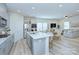 Bright kitchen with stainless appliances, island with sink, and open to dining and living area at 240 Orson Oaks Ln, Pineville, NC 28134