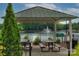 Covered picnic tables provide a shady spot to enjoy the scenic lake and fountain views at 240 Orson Oaks Ln, Pineville, NC 28134