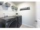 Convenient laundry room with modern washer and dryer, plus wire shelving for storage at 240 Orson Oaks Ln, Pineville, NC 28134