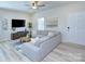 Bright living room features modern furniture, hardwood floors, and a cozy atmosphere at 240 Orson Oaks Ln, Pineville, NC 28134