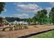 Community playground featuring modern play equipment, slides, and a scenic lake backdrop at 240 Orson Oaks Ln, Pineville, NC 28134