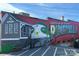 Colorful mural depicting a train station and the town name: Welcome to Historic Pineville at 240 Orson Oaks Ln, Pineville, NC 28134
