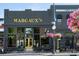Attractive exterior of Margaux's restaurant, featuring large windows, a yellow door, and inviting outdoor seating at 240 Orson Oaks Ln, Pineville, NC 28134