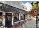 Inviting Two Buck Saloon exterior featuring a white brick facade and outdoor seating at 240 Orson Oaks Ln, Pineville, NC 28134