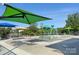 Colorful splash pad with various water features and shade canopies at 240 Orson Oaks Ln, Pineville, NC 28134