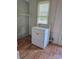 Well-lit laundry area with dryer and storage, perfect for convenient chores at 29 Willow St # 31, Badin, NC 28009