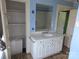 Bathroom features a white vanity with a mirror and open closet space for storage at 29 Willow St, Badin, NC 28009